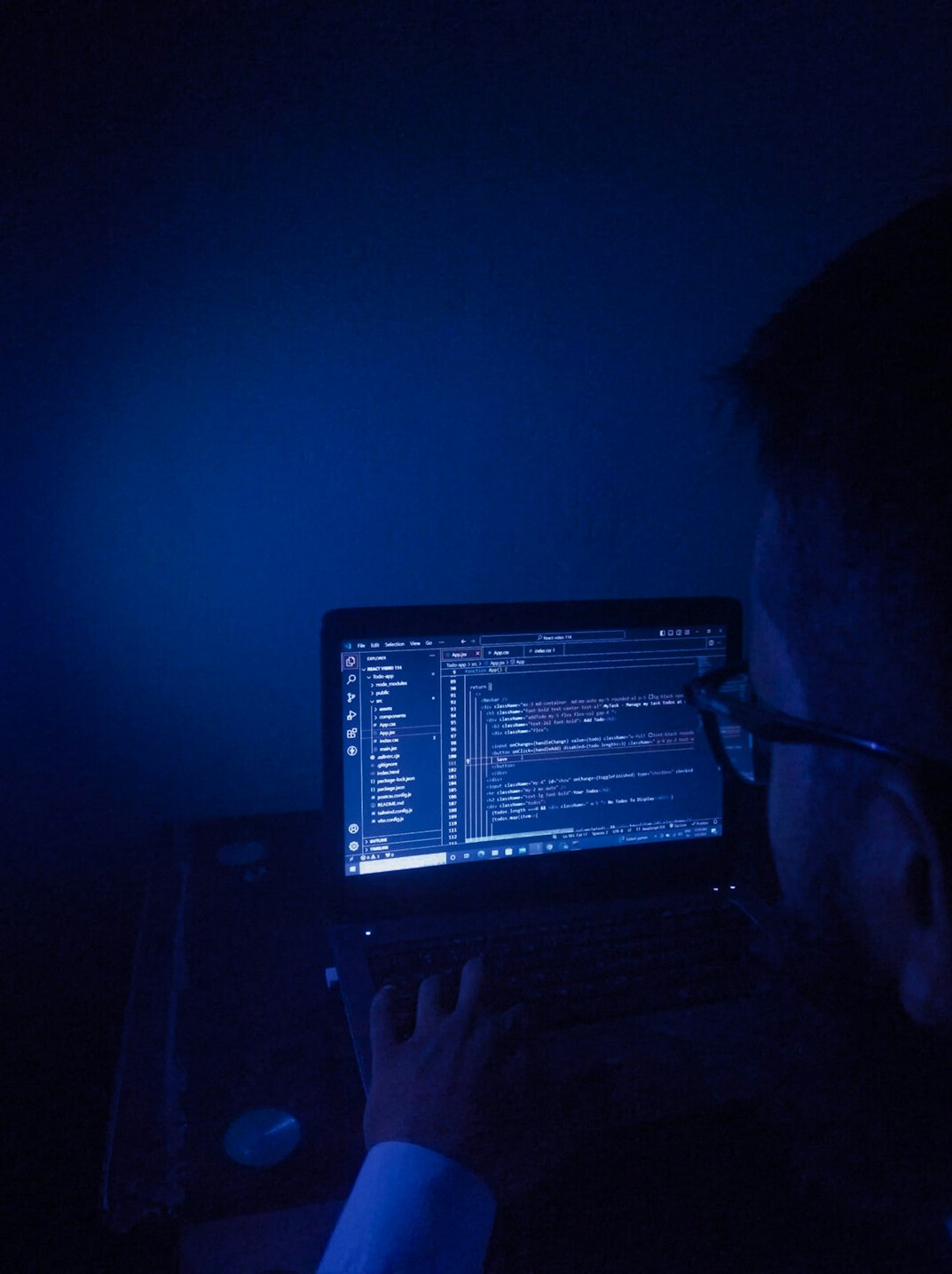 man coding on laptop