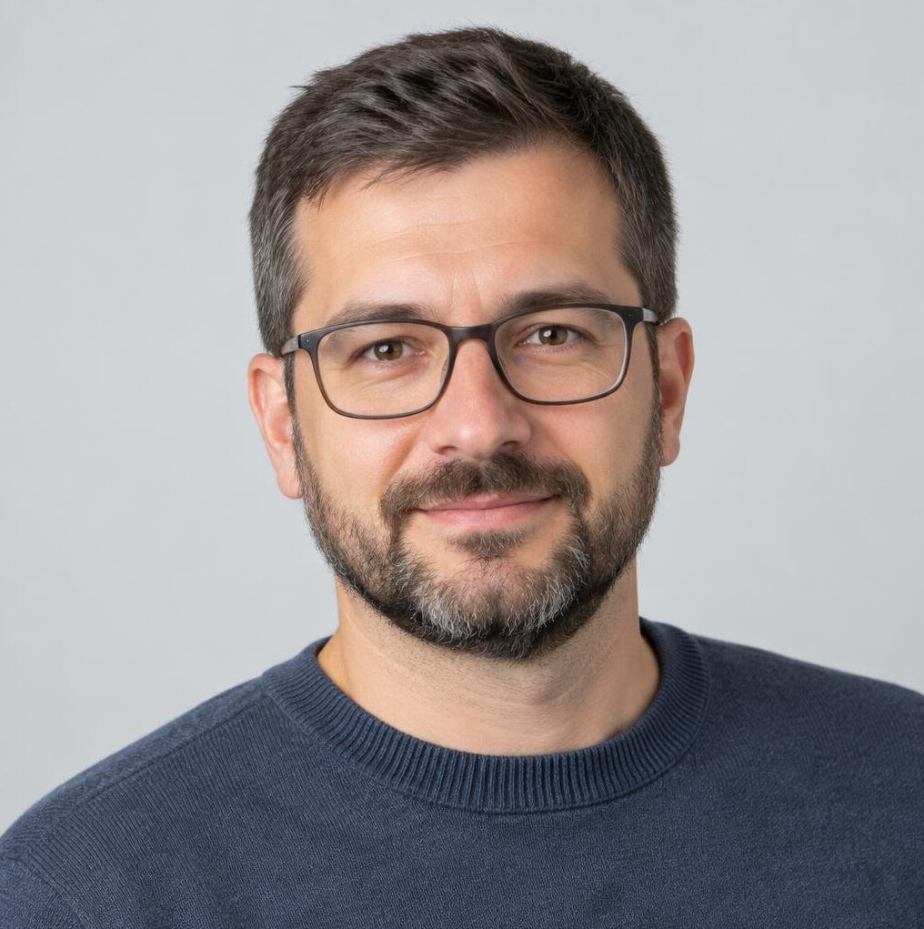 Studio portrait of a Croatian man with glasses and a beard